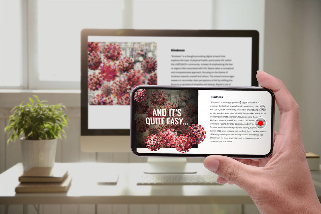 A hand holding a smartphone displaying a digital artwork titled 'Kindness,' featuring red virus-like spheres decorated with pink roses and the text 'And it's quite easy...' in bold. In the background, a desktop screen shows the same artwork and accompanying descriptive text, with a modern indoor setup including a plant and stacked books.