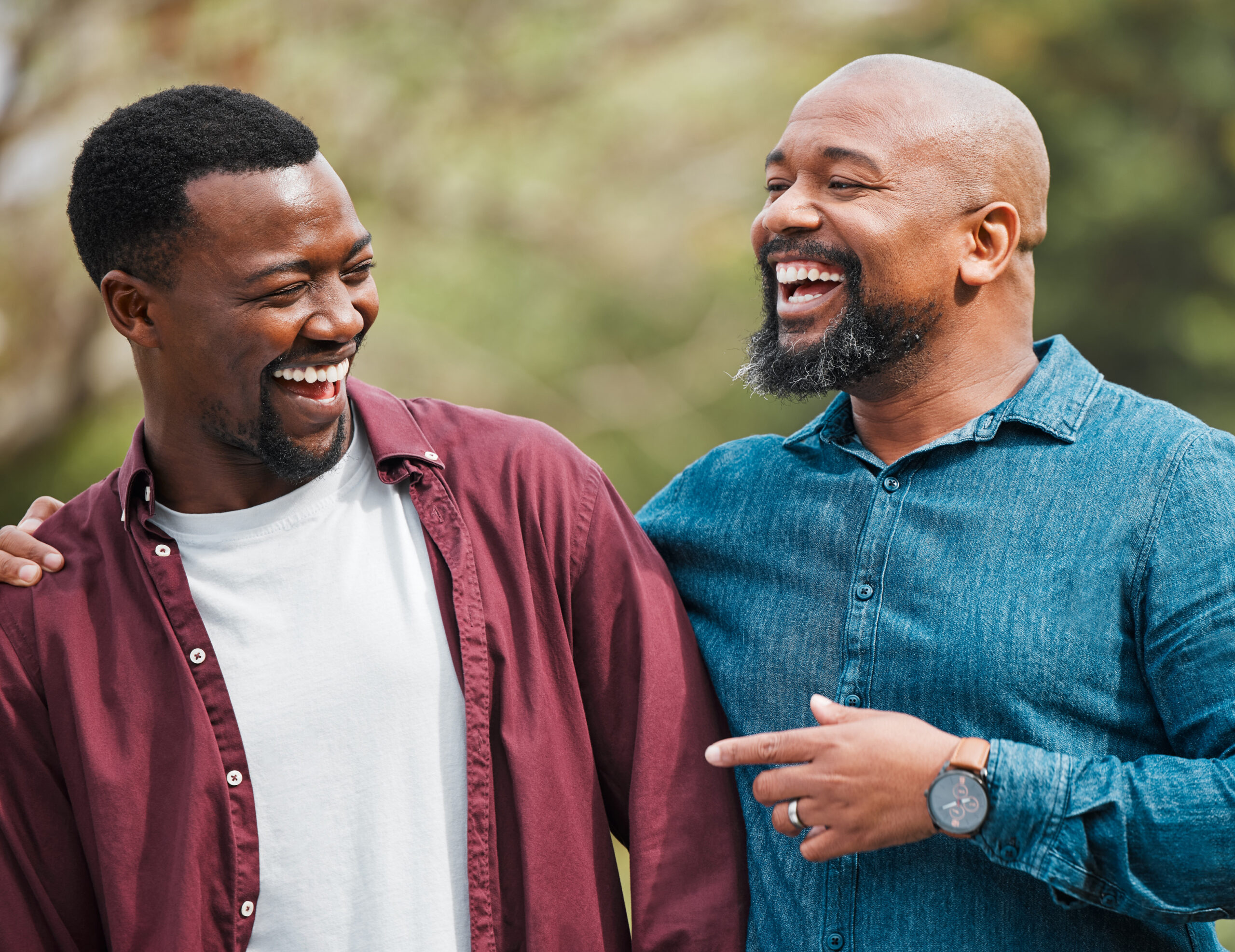 Two black men smiling at each other