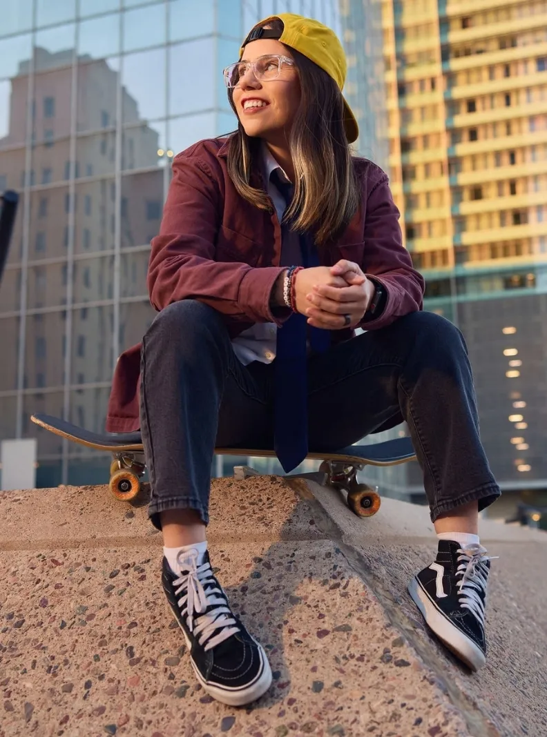 TESTING_AFTER_DARK---KG---13951-R--cropped | Spectrum Medical A woman at a skatepark casually sits on her skateboard smiling and looking hopefully out to the distance.